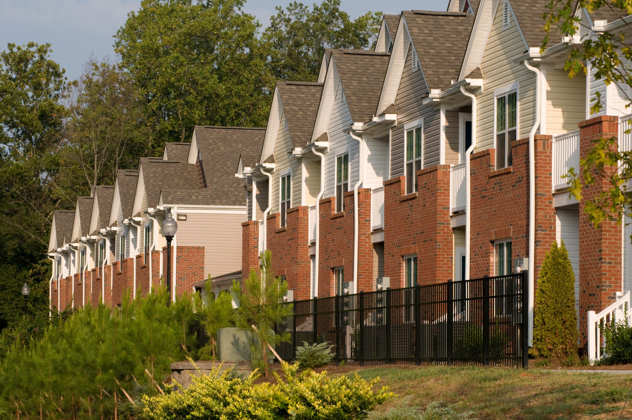 Row of brick townhouses with gabled roofs