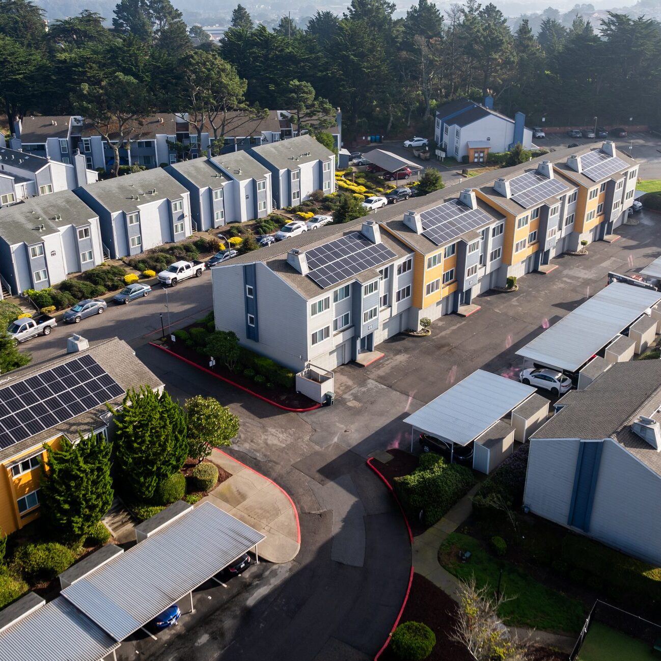 Aerial apartment complex with rooftop solar panels